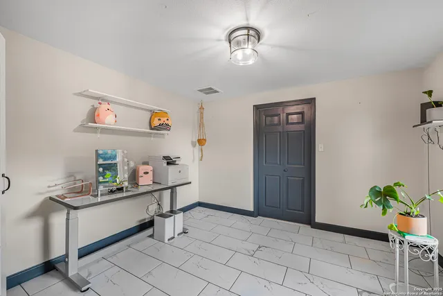 a spacious bedroom with a bed and glass door