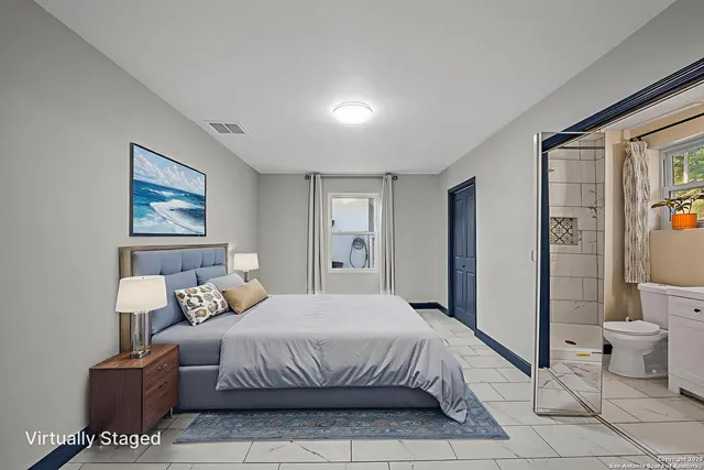 a bathroom with a toilet a sink and mirror