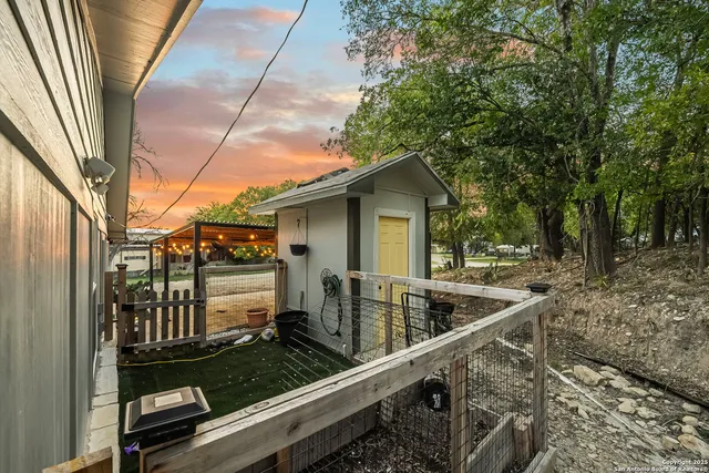 a view of a house with backyard and sitting area