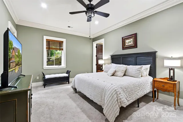 a bedroom with a bed desk and a window