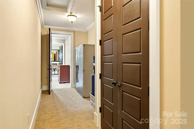 a view of a hallway with wooden shelves