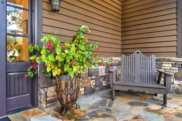a front view of a house with a yard and potted plants