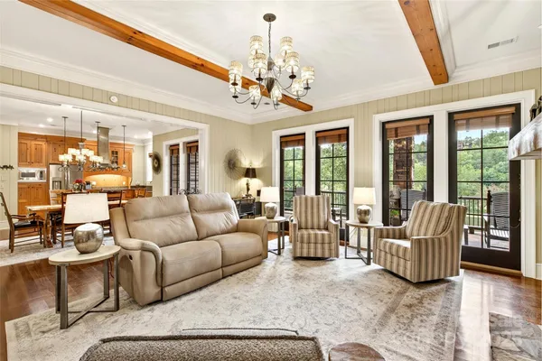 a living room with furniture and a chandelier