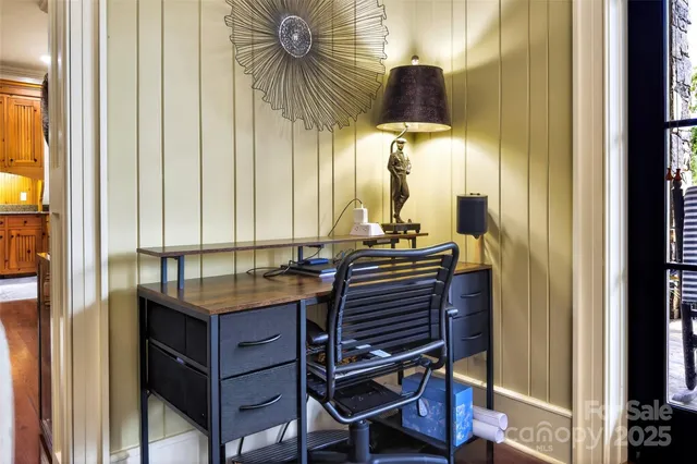 a room with a table chairs and a window