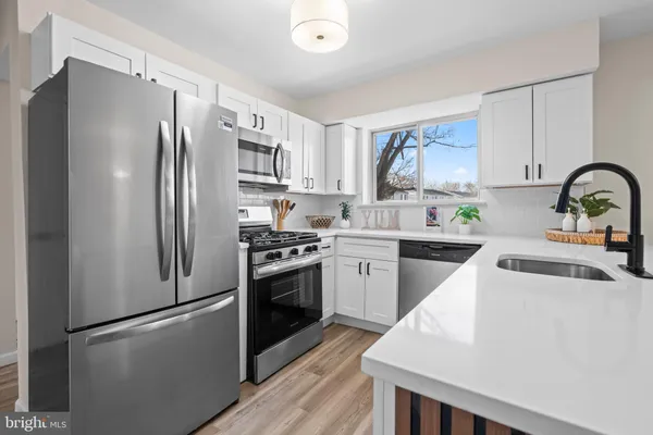 a kitchen with a refrigerator stove and sink