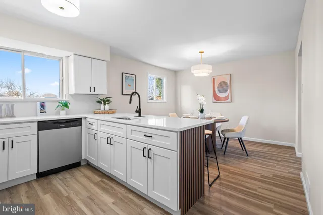 a kitchen with sink cabinets and wooden floor