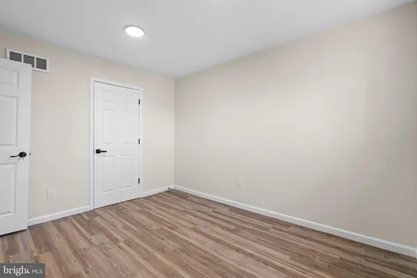 a view of room with wooden floor