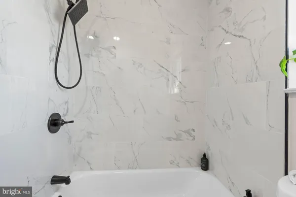 a bathroom with a bath tub with a shower