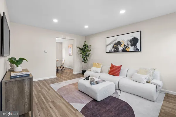a living room with furniture and a potted plant