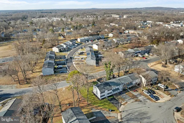 an aerial view of residential houses with outdoor space