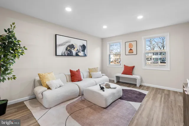 a living room with furniture and a potted plant