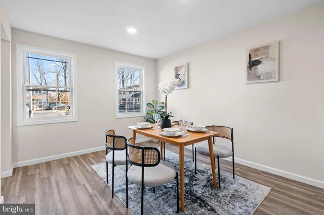 a view of a room with furniture and wooden floor