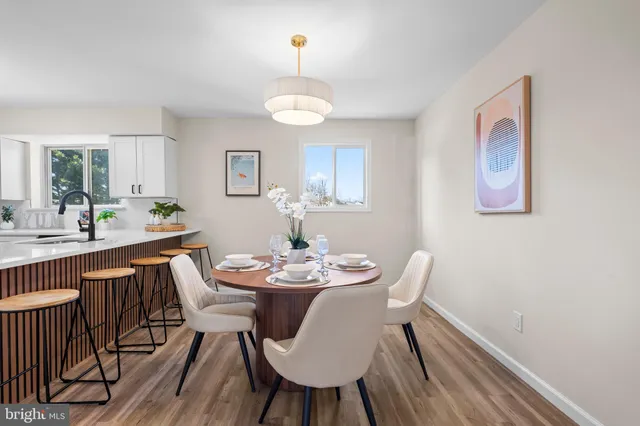 a view of a dining room with furniture window and wooden floor
