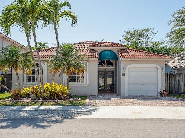 3436 Southwest 152nd Pass Miami, FL 33185 - Photo 1 of 36 a front view of a house with garage