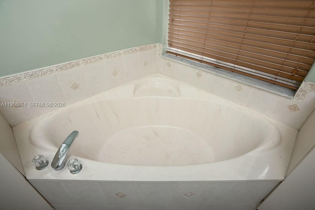 3436 Southwest 152nd Pass Miami, FL 33185 - Photo 18 of 36 a bath tub sitting next to a white sink