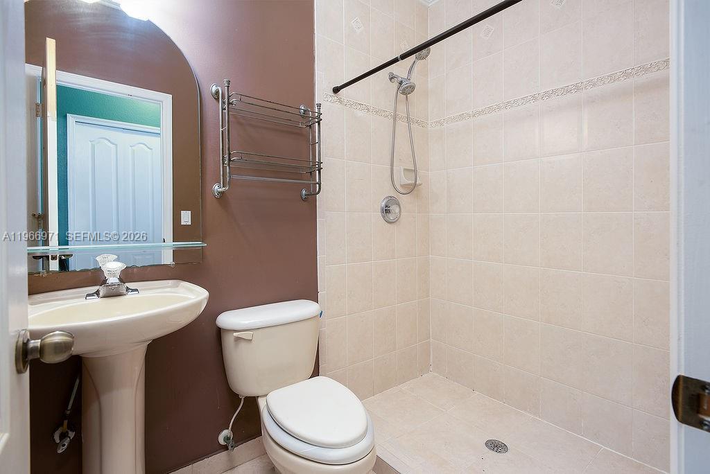 3436 Southwest 152nd Pass Miami, FL 33185 - Photo 22 of 36 a bathroom with a sink a toilet and shower