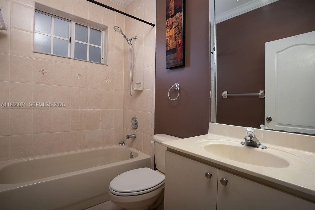 3436 Southwest 152nd Pass Miami, FL 33185 - Photo 24 of 36 a bathroom with a toilet a sink a mirror a bathtub and shower