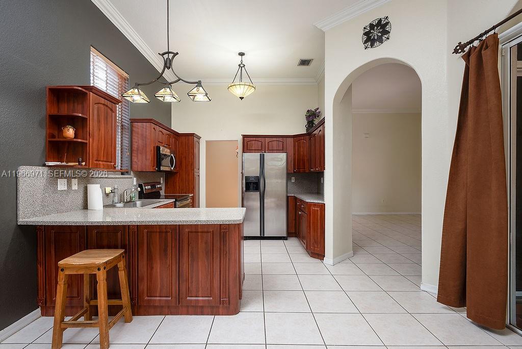 3436 Southwest 152nd Pass Miami, FL 33185 - Photo 5 of 36 a view of a kitchen with a sink and chandelier