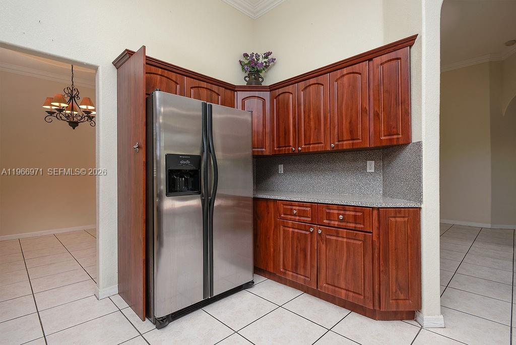 3436 Southwest 152nd Pass Miami, FL 33185 - Photo 9 of 36 a kitchen with stainless steel appliances granite countertop a refrigerator and a sink