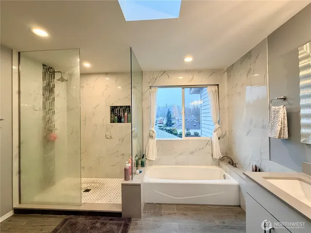 a bathroom with a bathtub and a shower