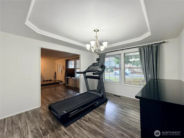 a living room with furniture and a chandelier