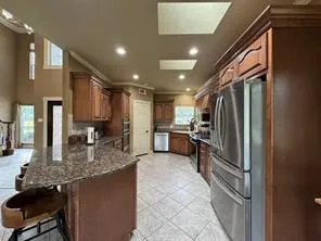 a kitchen with lots of counter top space appliances and cabinets