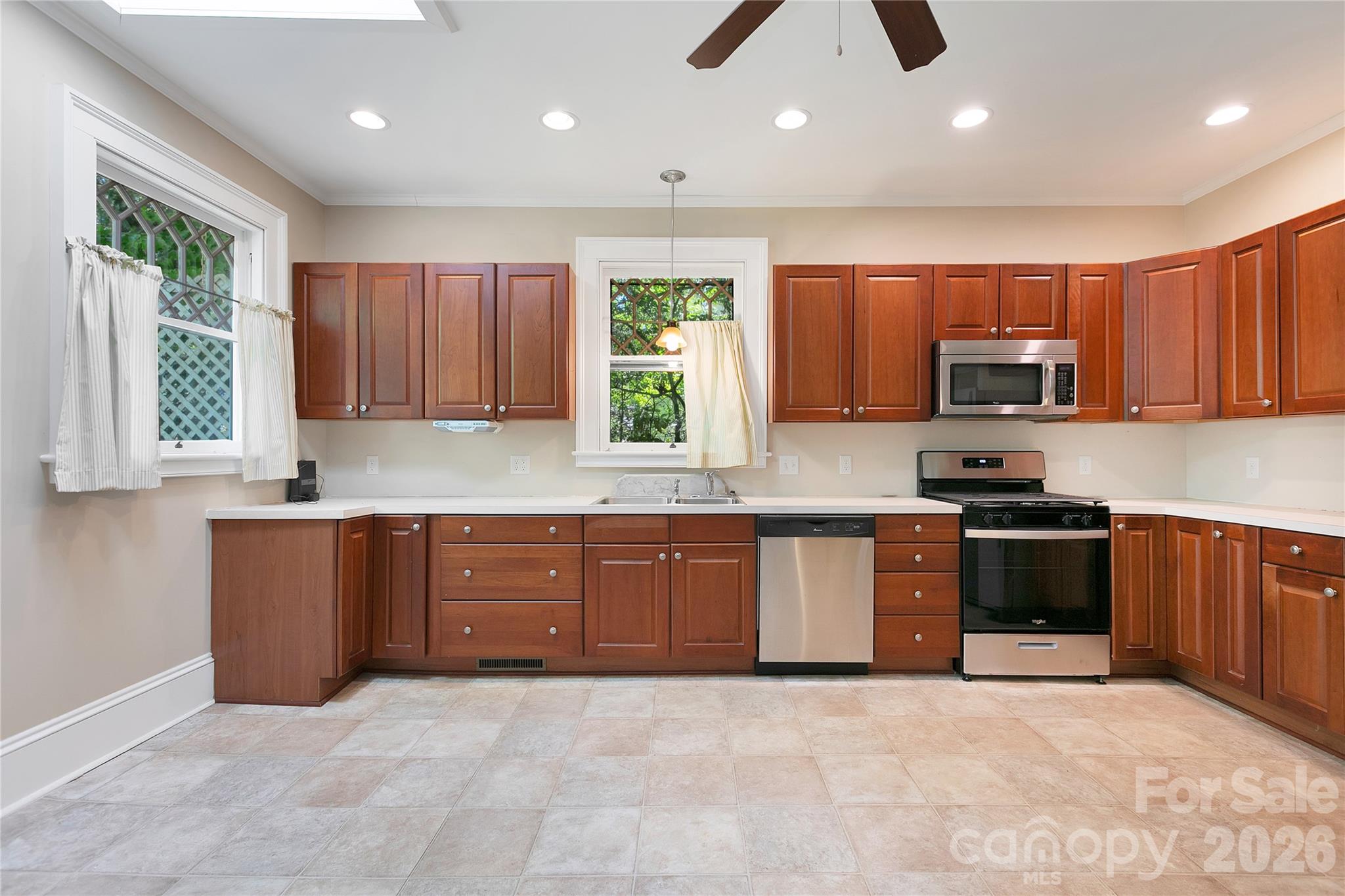 208 West Probart Street Brevard, NC 28712 - Photo 26 of 48 a large kitchen with stainless steel appliances granite countertop a stove a sink and a microwave