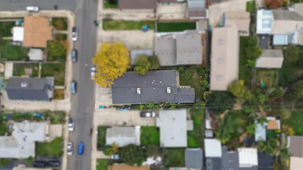 an aerial view of a house with a yard