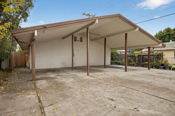 a view of a house with a patio and backyard