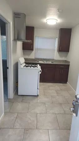 a kitchen with a sink a counter top space cabinets and stainless steel appliances