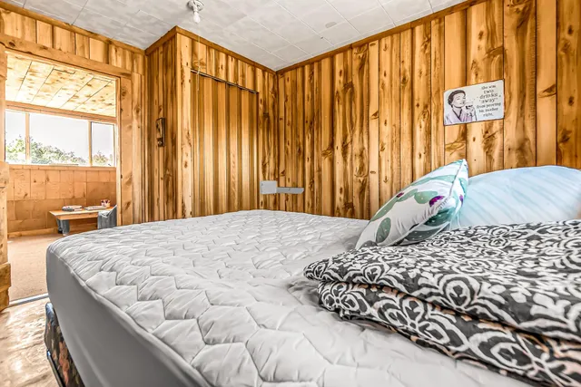 a bed room with a bed and a window