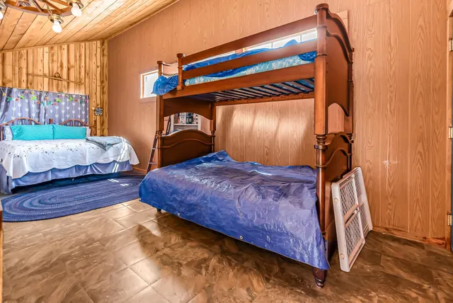 a bedroom with a bed next to a window