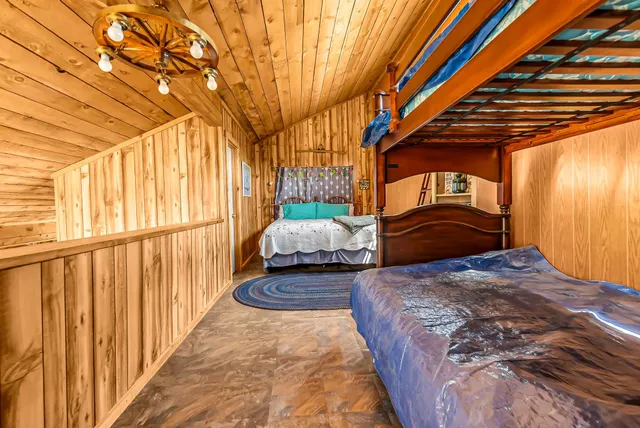 a bed sitting in a bedroom next to a window