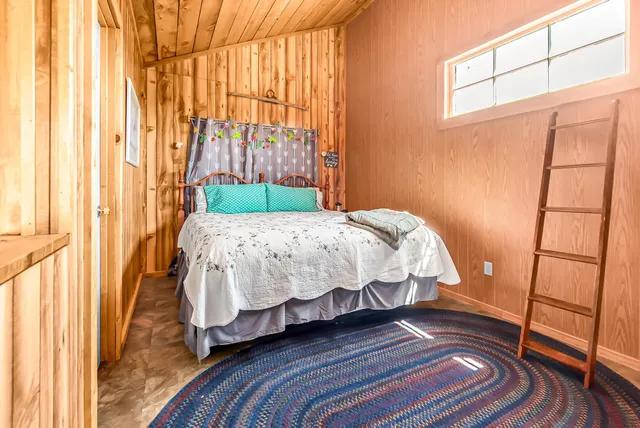 a bedroom with a bed and a window