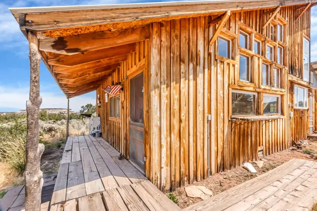 a view of a balcony with furniture and wooden floor