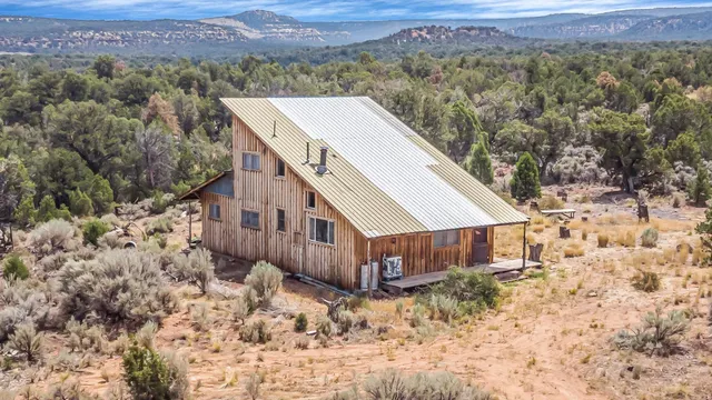 an aerial view of a house with a yard and lake view