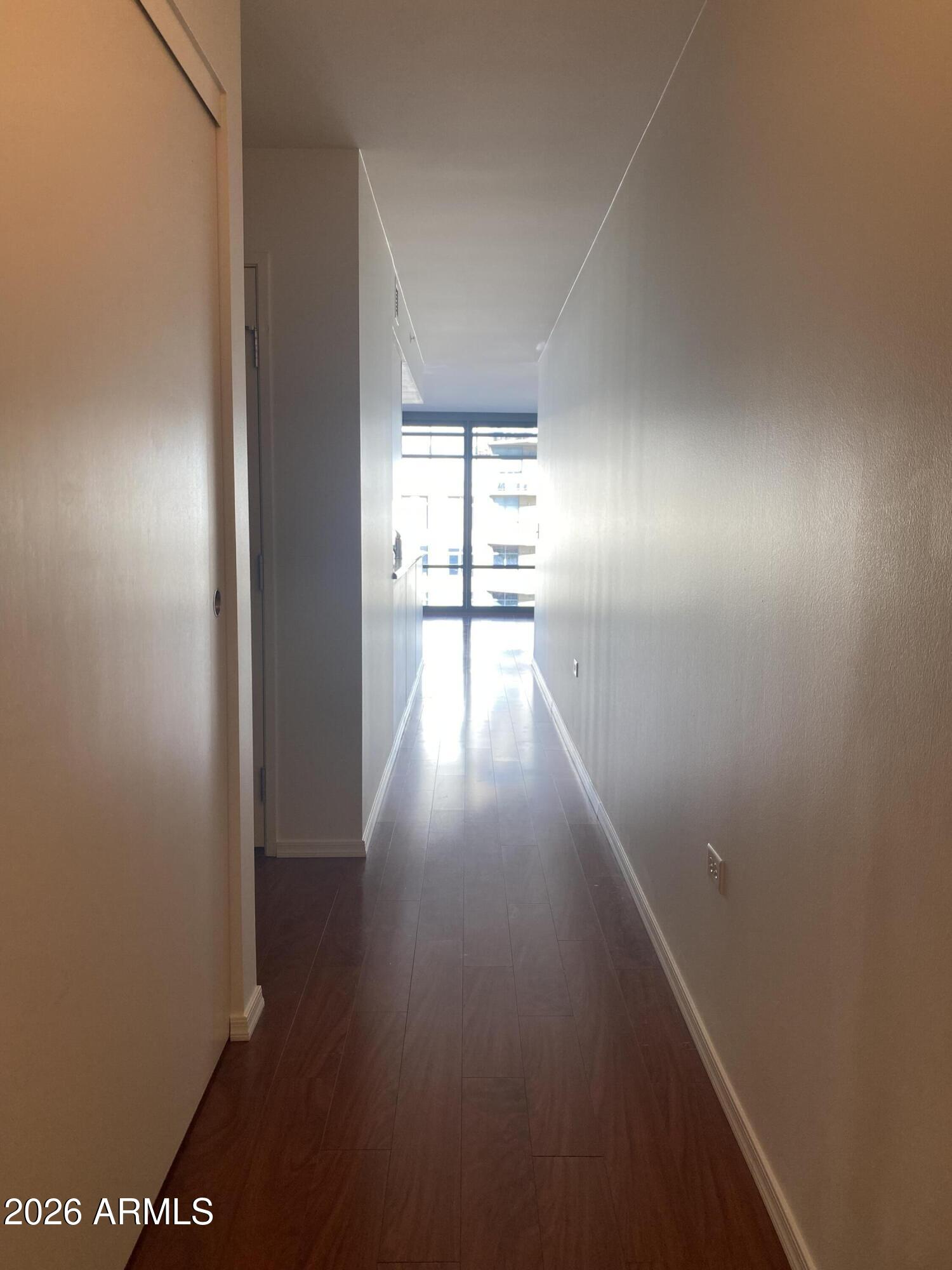 4808 North 24th Street, Unit 1102 Phoenix, AZ 85016 - Photo 1 of 20 a view of empty room with wooden floor and fan