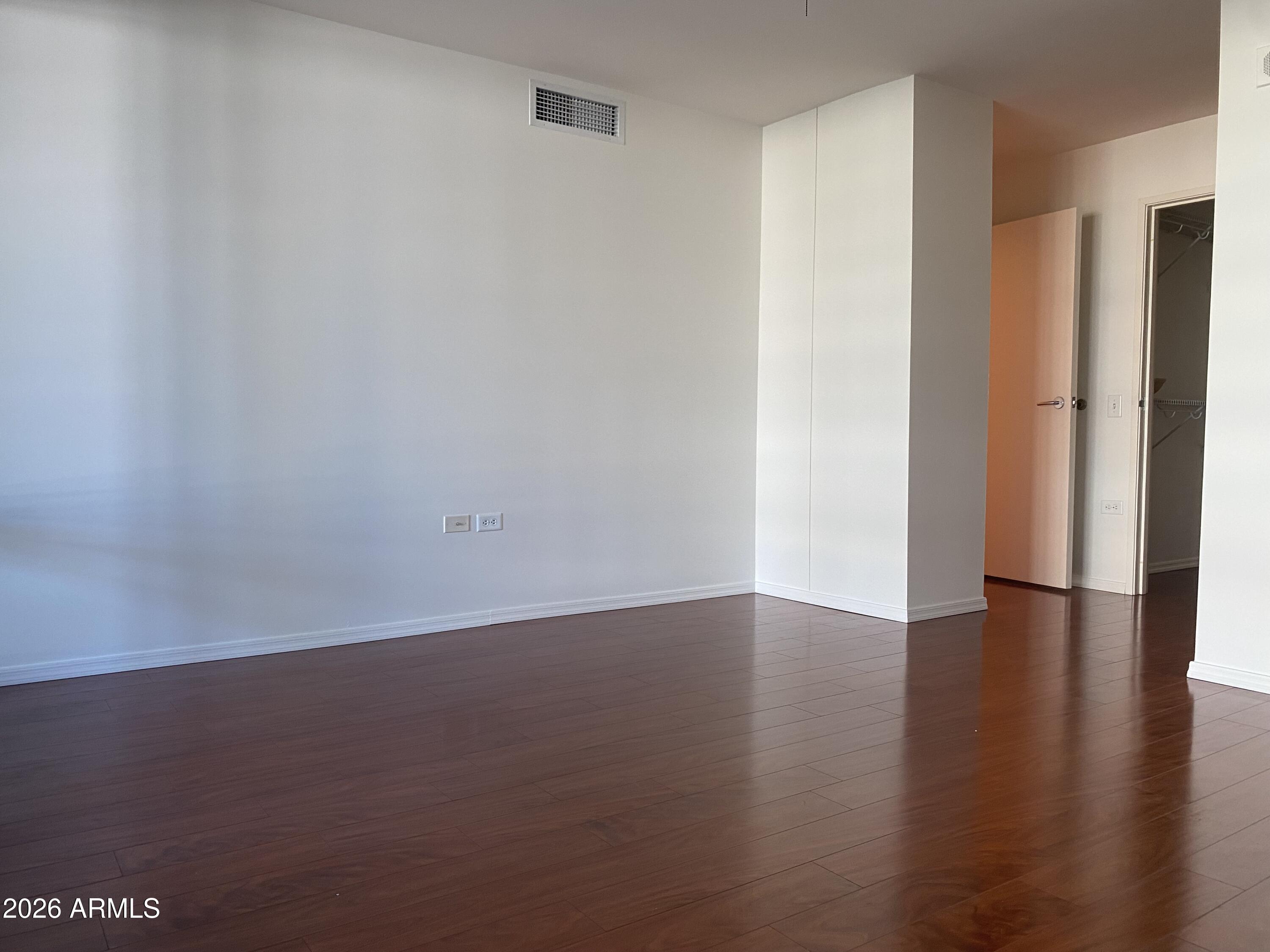 4808 North 24th Street, Unit 1102 Phoenix, AZ 85016 - Photo 11 of 20 a view of an empty room with wooden floor