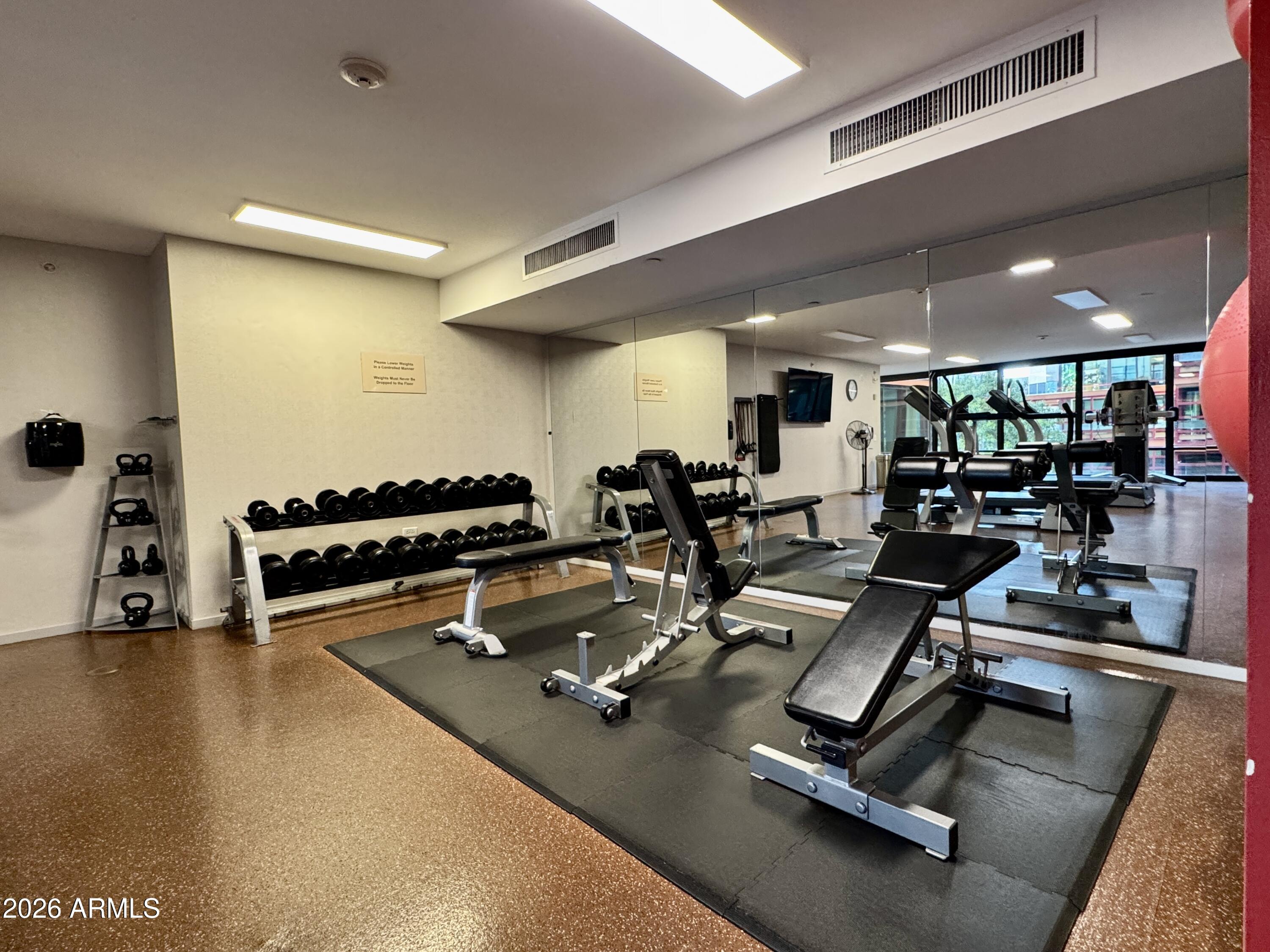 4808 North 24th Street, Unit 1102 Phoenix, AZ 85016 - Photo 15 of 20 a room with gym equipment and a large window