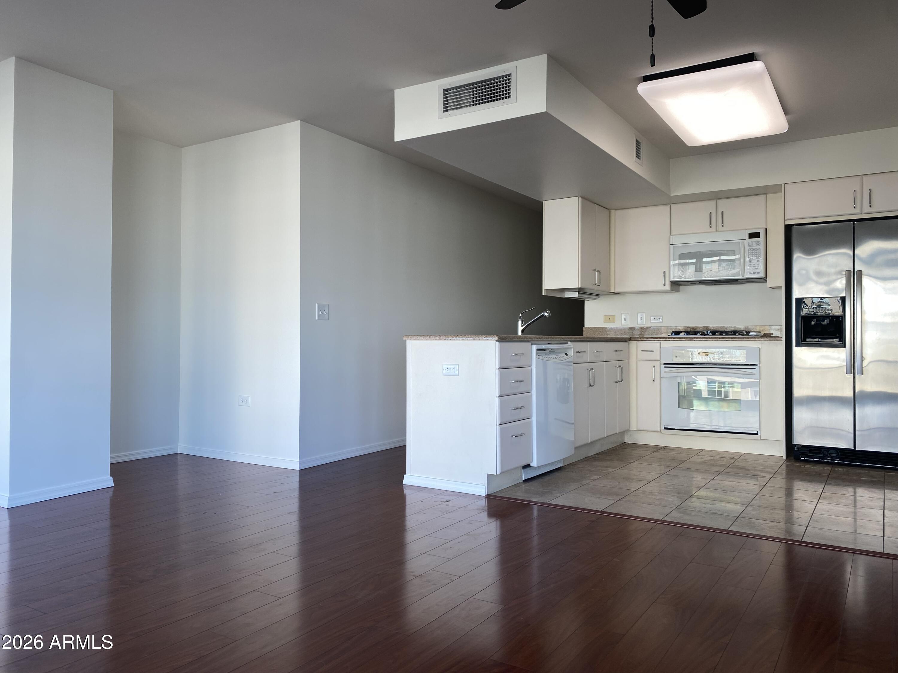 4808 North 24th Street, Unit 1102 Phoenix, AZ 85016 - Photo 5 of 20 a kitchen with granite countertop a stove and a refrigerator