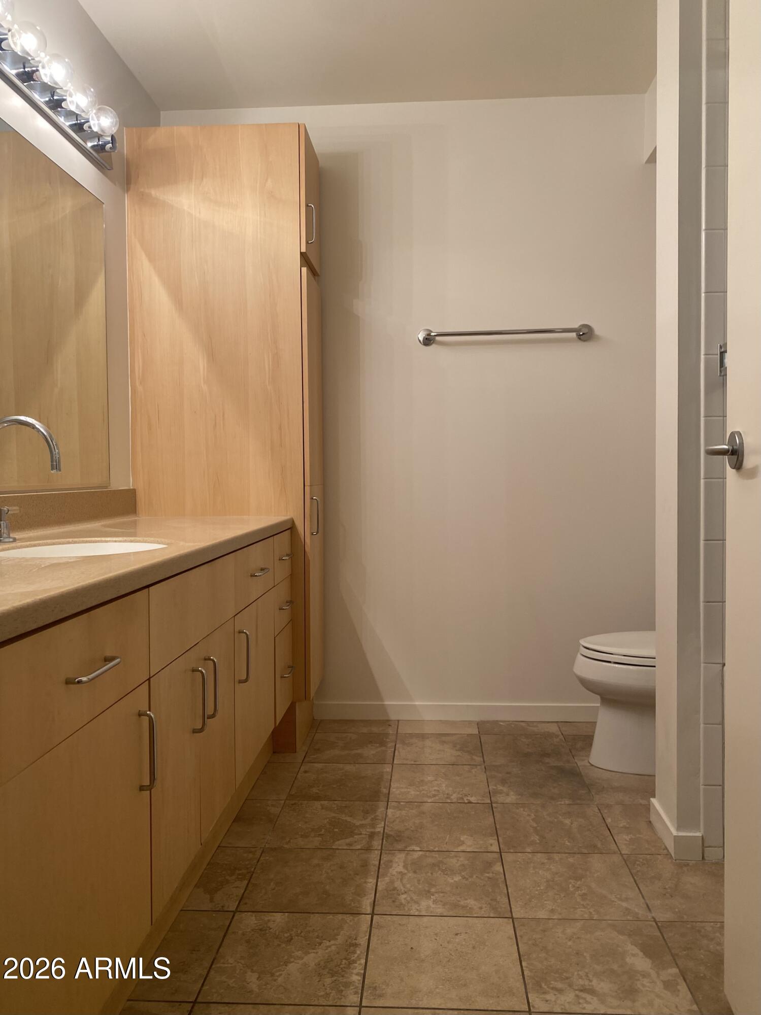 4808 North 24th Street, Unit 1102 Phoenix, AZ 85016 - Photo 8 of 20 a bathroom with a sink a toilet and a mirror