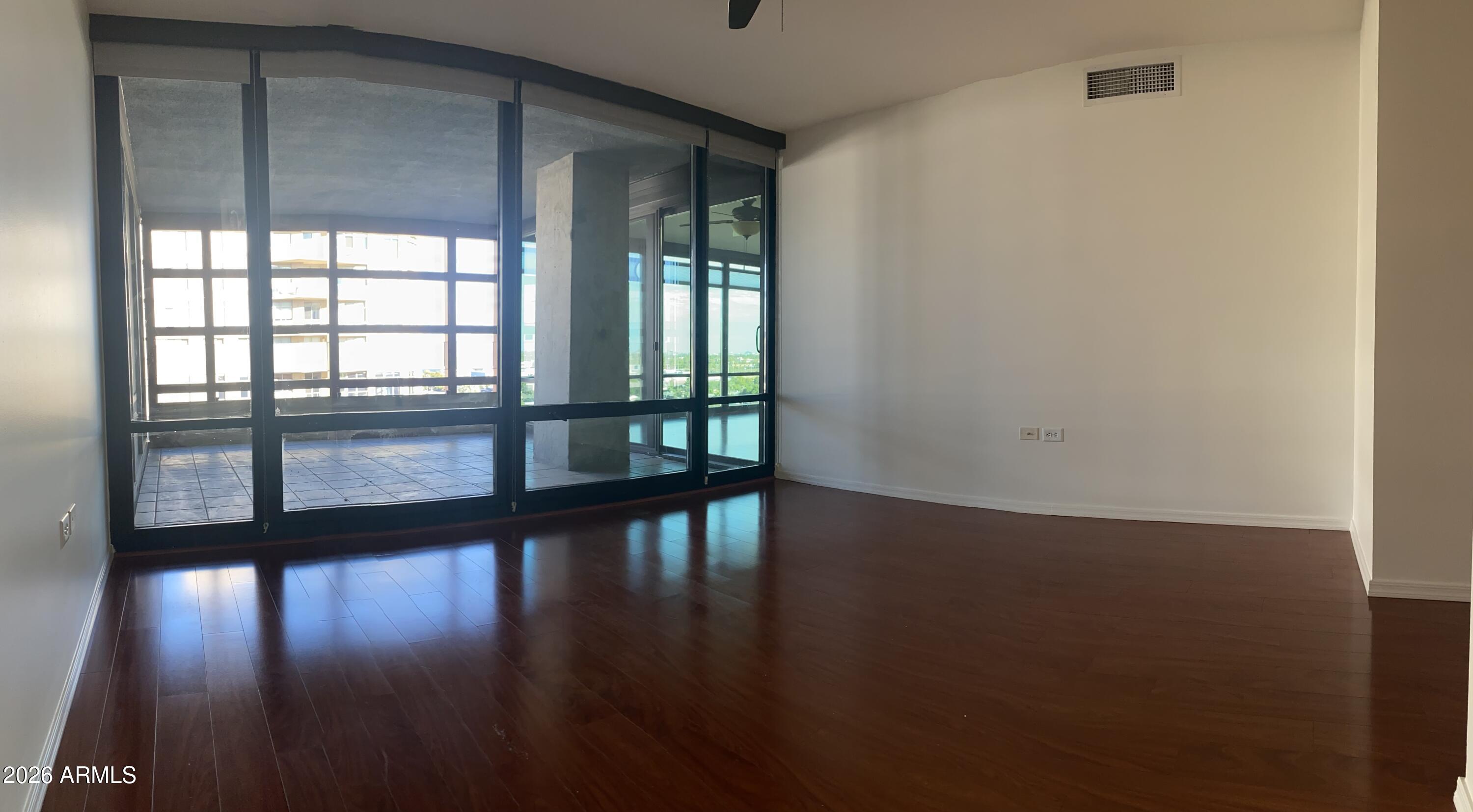 4808 North 24th Street, Unit 1102 Phoenix, AZ 85016 - Photo 10 of 20 a view of empty room with wooden floor and fan