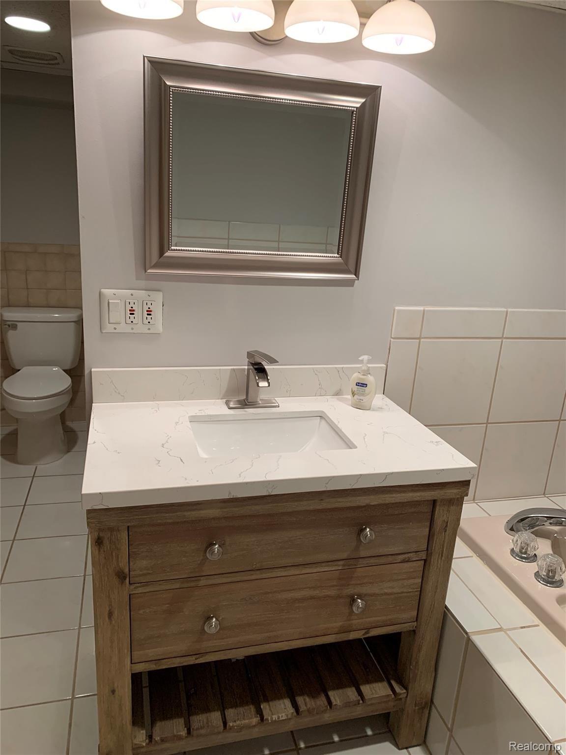4859 Crooked Lake Road Howell, MI 48843 - Photo 49 of 90 Double GFI plugs in basement bath are up to code