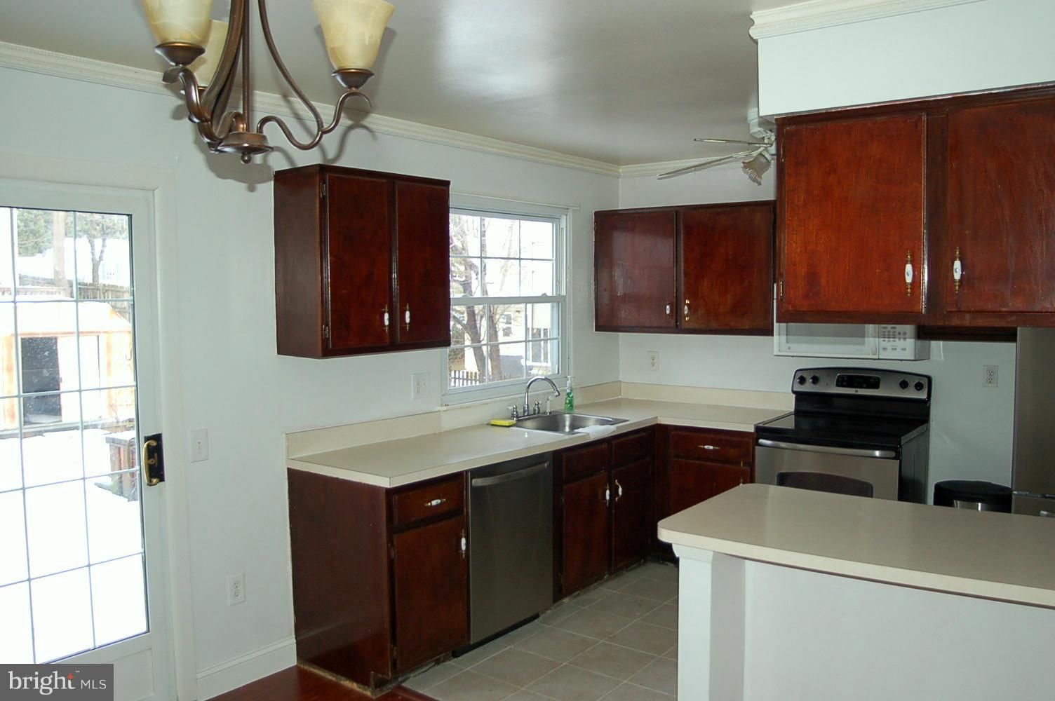 111 Applecreek Road Frederick, MD 21702 - Photo 5 of 21 a kitchen with a sink a stove cabinets and a window