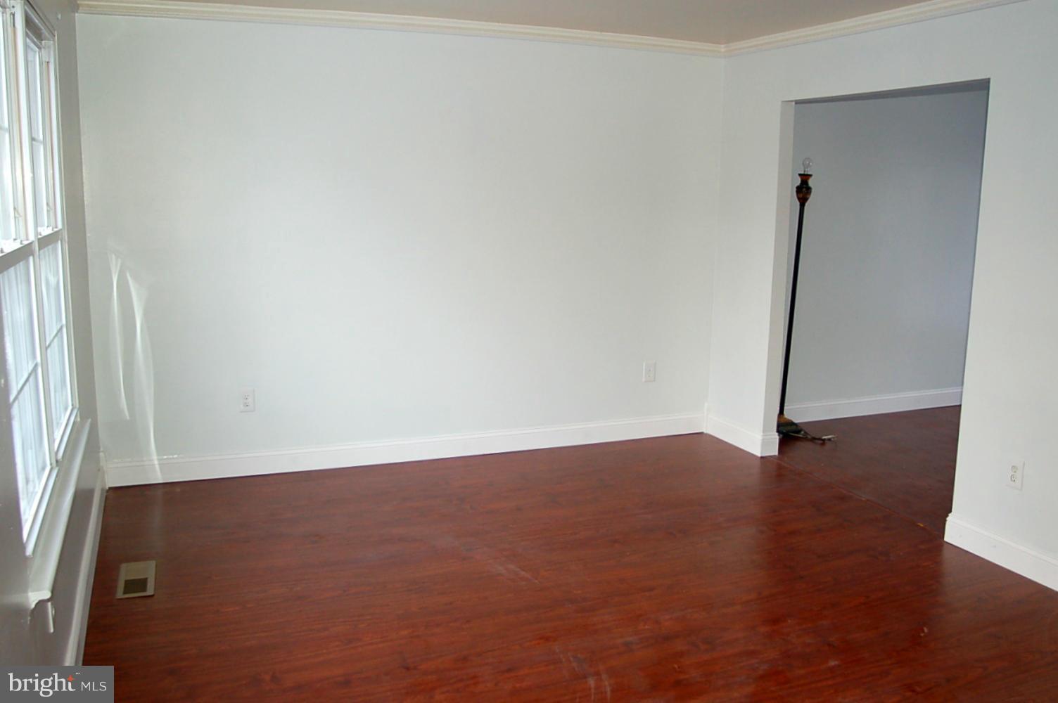 111 Applecreek Road Frederick, MD 21702 - Photo 8 of 21 an empty room with wooden floor and a window