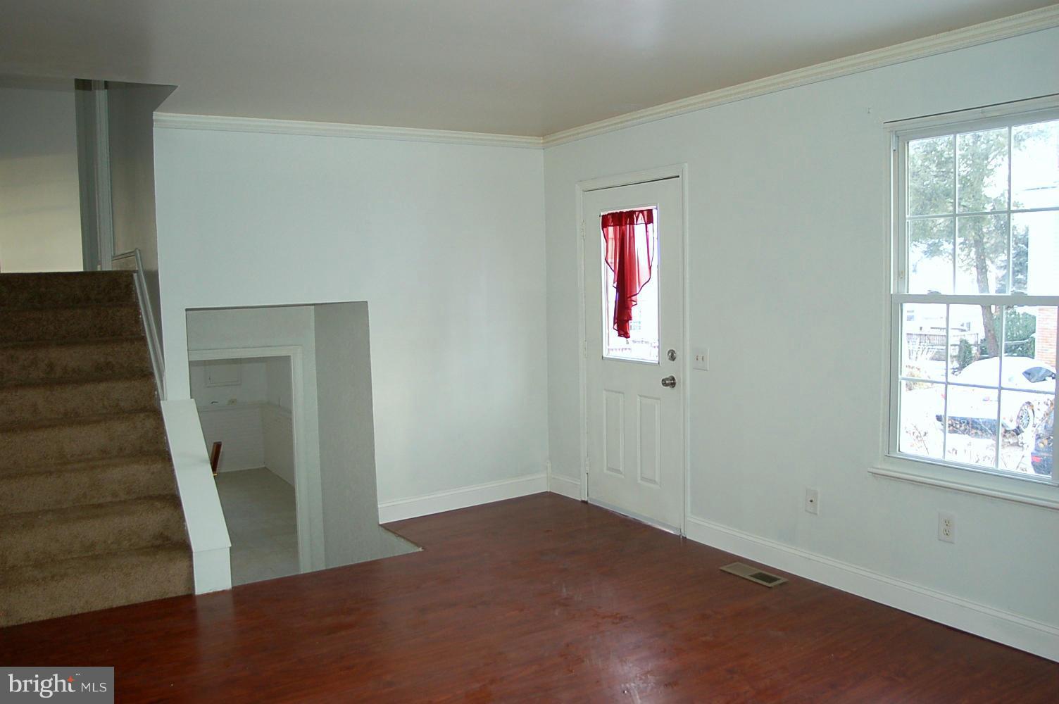 111 Applecreek Road Frederick, MD 21702 - Photo 9 of 21 an empty room with wooden floor and windows