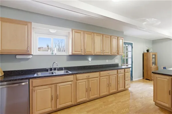 a kitchen with stainless steel appliances granite countertop white cabinets sink and dishwasher