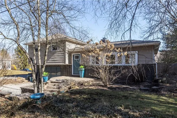 a view of a house with a yard covered with snow