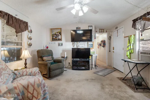 a living room with furniture a flat screen tv and a fireplace