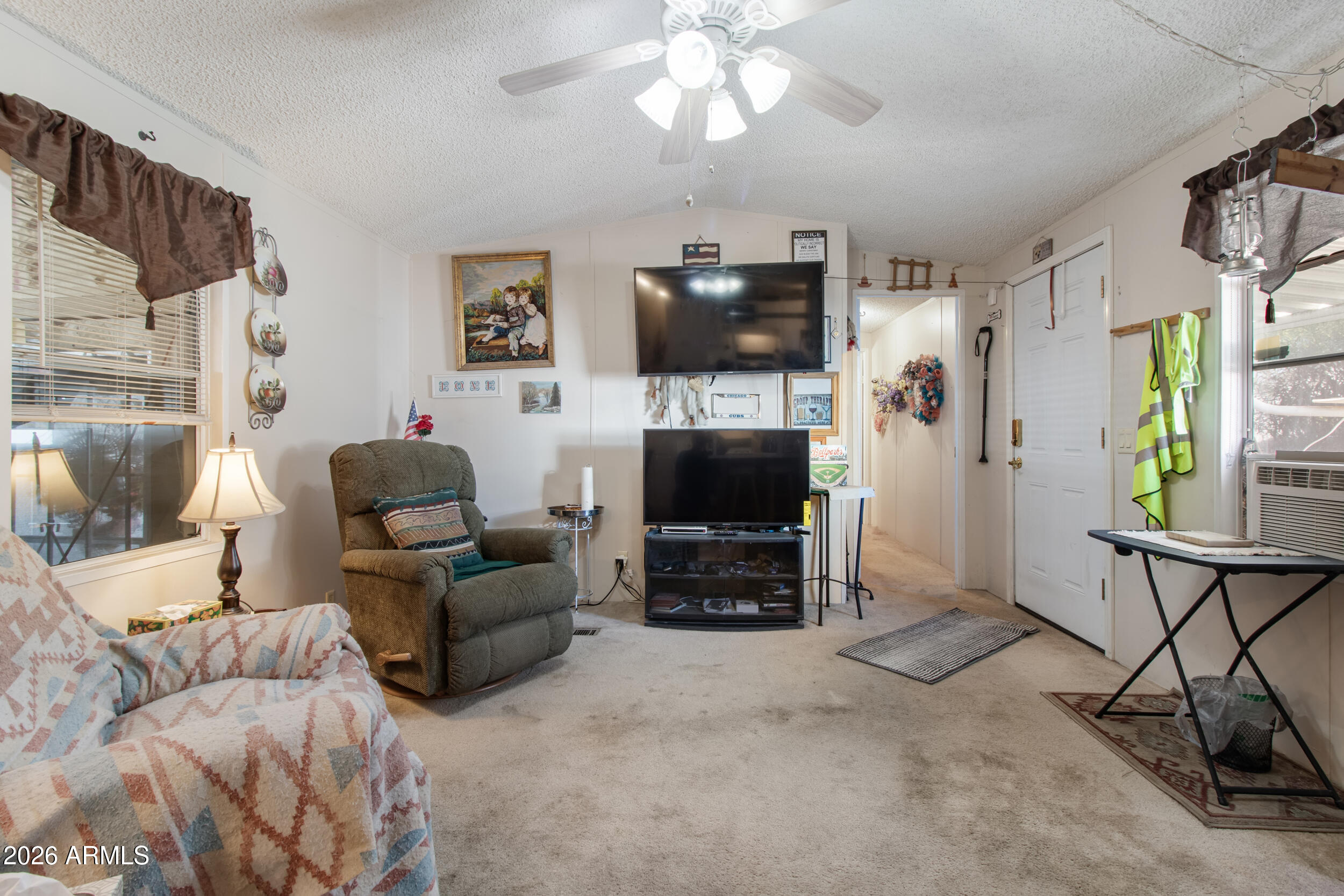 2121 North Center Street, Unit 15 Mesa, AZ 85201 - Photo 11 of 50 a living room with furniture a flat screen tv and a fireplace